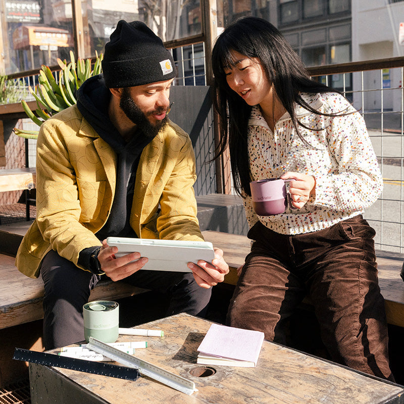 12oz-rise-mug-w8 12oz_rise_coffee_mug_dusty_orchid_couple_city_patio_square.jpg