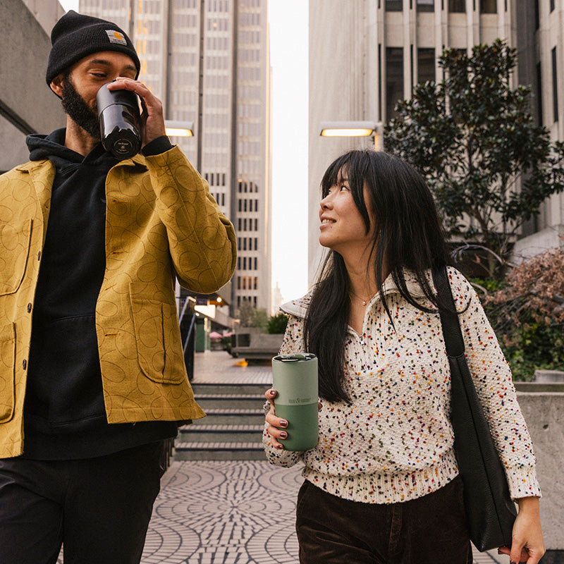 16oz-rise-tumbler-f4 16oz_rise_tumbler_black_iceberg_couple_drink_city_street_square.jpg