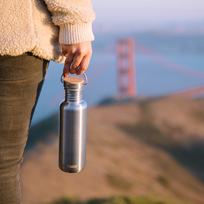 27oz-reflect-with-bamboo-cap-u9 K27SSLRF-BS-BAMBOO_reflect_bottle_bridge_lifestyle.jpg