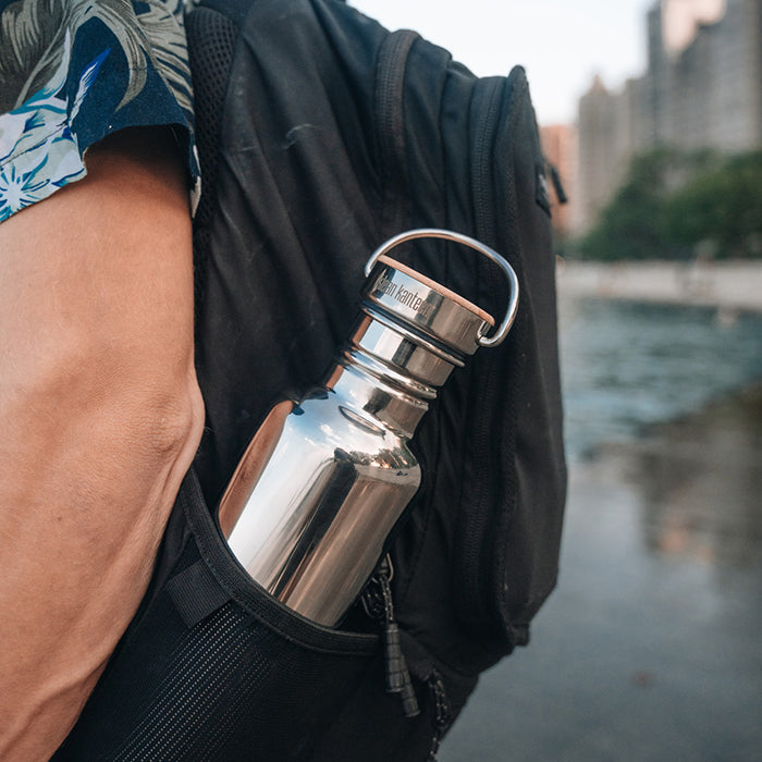 27oz-reflect-with-bamboo-cap-u9 K27SSLRF-MS-BAMBOO_reflect-bottle_backpack_lifestyle.jpg